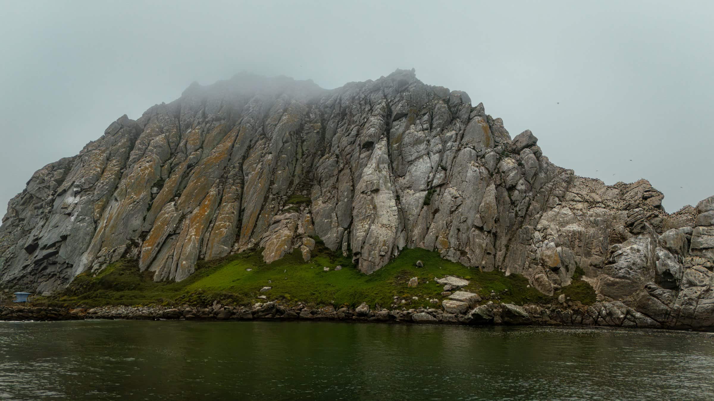 Morro Rock rising out of coastal fog, Morro Bay, California